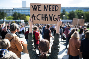 Protestor holding we need a change sign.