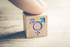 Finger resting on a wood block featuring Transgender, LGBT or Intersex Icons