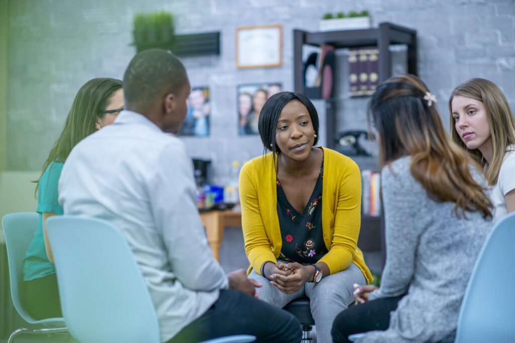 Social worker working with diverse group of clients