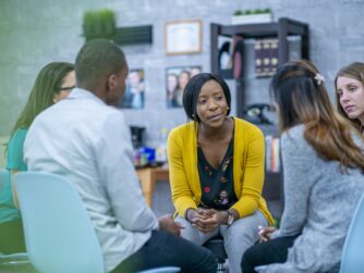 Social worker working with diverse group of clients