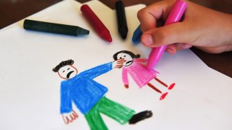 Crayon drawing of child and adult with the adult pointing angrily at the child.