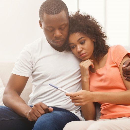 Sad black couple after pregnancy test result