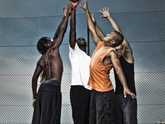 High school students playing basketball in the street