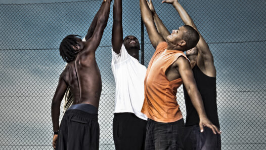 High school students playing basketball in the street