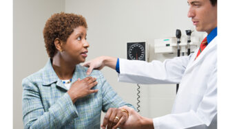 Black middle class woman being examined by white male doctor.