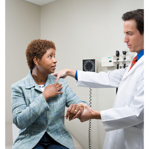 Black middle class woman being examined by white male doctor.
