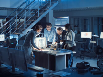 Production designers discussing the design of new technologies in a high tech computing environment.